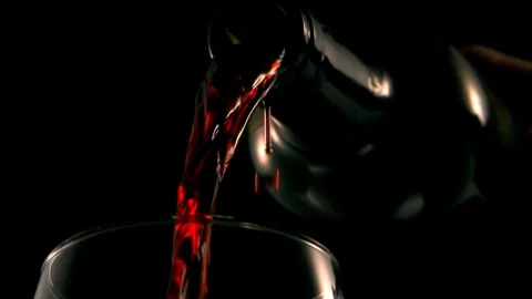 Close up of bottle pouring red wine into glass. Slow motion Stock Footage 89650833