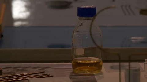 Close up on a bottle with yellow liquid Stock Footage 73763016