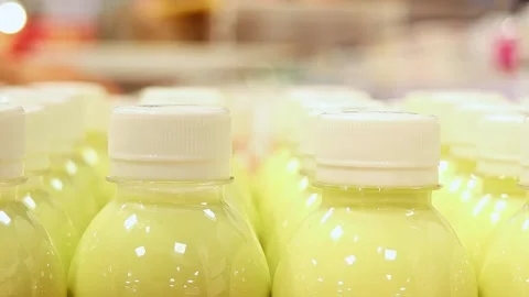 Close up of bottled dairy fruit drink on supermarket shelf Stock Footage 336663584
