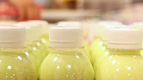 Close up of bottled dairy fruit drink on supermarket shelf Stock Footage 336663604
