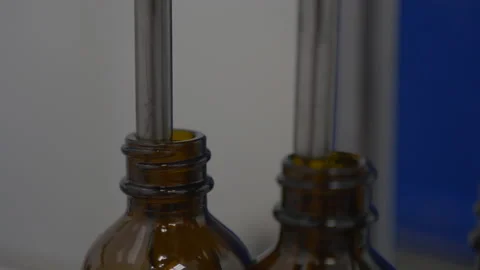 Close-up Of Bottles Being Filled With Liquid In Factory Stock Footage 137282320