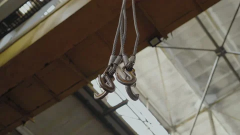 Close-up, Bottom view, Hanging from the Bridge Crane Metal Hooks on Cables Stock Footage 158849057