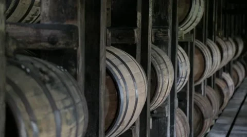 Close up of Bourbon Whiskey Barrels aging in a barn in Kentucky rick house Stock Footage 45548001