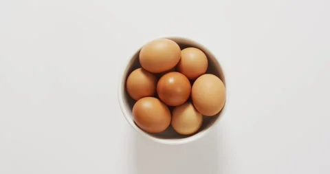 Close up of bowl of brown eggs with copy space on white surface Stock Footage 338433743