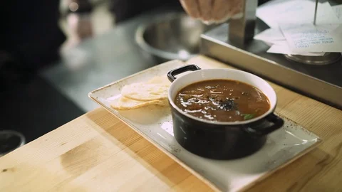 Close up of a bowl with a soup on the table in the kitchen restaurant 動画素材 117592120