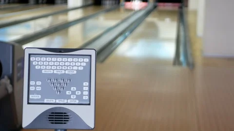 Close-up of bowling control panel with blurred man on background throwing ball 库存影片 116056923