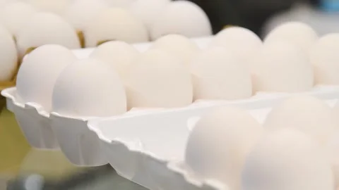 A close-up of a box filled with white eggs, offered for sale at a market or.. Stock Footage 331206874