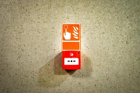 Close-up of box with fire  warning sign on marble wall . Stock Photos