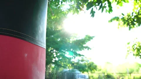 Close-up of boxer hits punching bag in outdoor gym Stock Footage 158938035