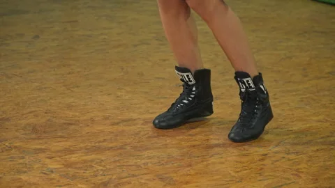 Close-Up of Boxing Footwork in Black Boots on a Gym Floor Stock Footage 347018071