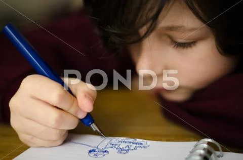 Close-up of boy (12-13) drawing in note pad Stock Photos