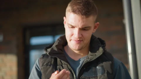 Close up boy about to smoke changes mind and discards cigarette Stock Footage 307066217