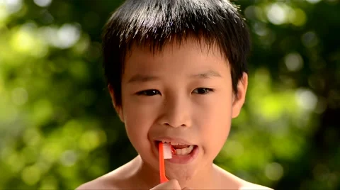 Close up boy brush tooth on green bokeh background Video stock 51802142