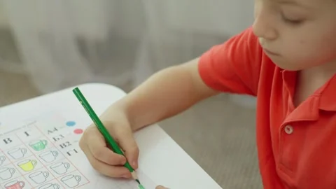 Close-up of a boy doing an individual task in an elementary school. Stock Footage 250020917