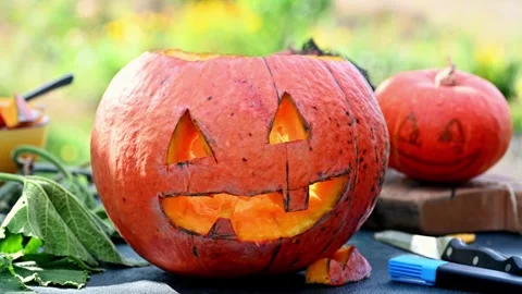 Close up of boy drawing on pumpkin, decoration for Halloween season. Woman .. Video stock 272458861
