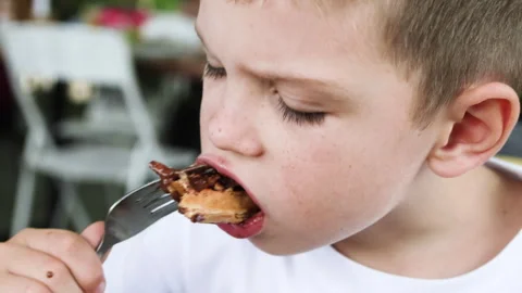 Close up of boy eating waffle. Stock Footage 277191810