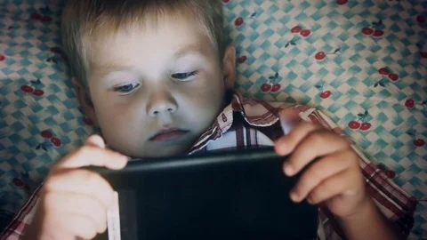 Close-up of boy face looking at tablet computer Stock Footage 79071704