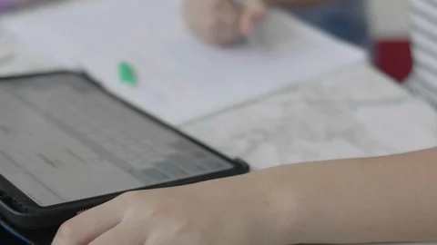Close up boy hands doing homework using a tablet computer Video stock 109452825