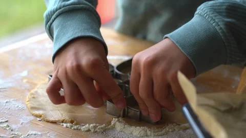 Close-up of boy hands pressing festive gingerbread shapes into the dough. Stock Footage 293747106