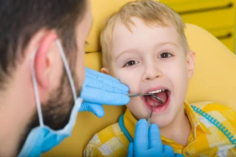 Close up of boy having his teeth examined by a dentist Stock Photos