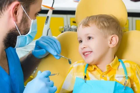 Close up of boy having his teeth examined by a dentist Stock Photos