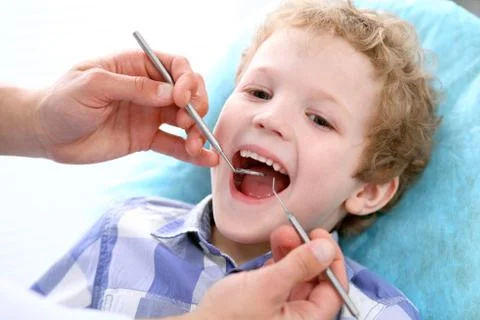 Close up of boy having his teeth examined by a dentist Stockfoto's