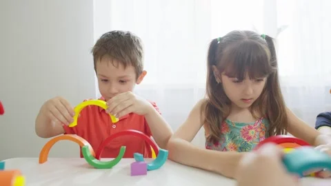 Close-up of a boy making a rainbow of different colors in a kindergarten Stock Footage 256911787