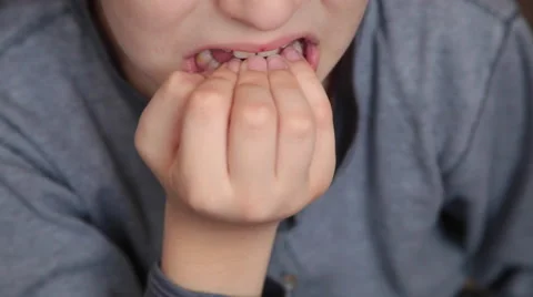 Close up of a boy nervously biting his fingernails, forming a bad habit Stock Footage 60808445