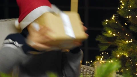 Close-up of a boy in a New Year's hat rejoicing at a New Year's gift. New Year Video stock 167239004