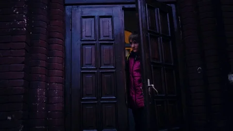 Close up boy open door goes out of school to the street with a backpack old Stock Footage 99255981