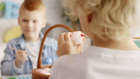 Close up of boy painting easter egg  Stock-Footage 103659541