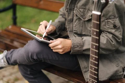 Close-up of boy painting in tablet using pencil. Young designer using tablet Stock-Fotos