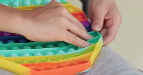 Close up of boy playing popit toy. Video stock 158323548