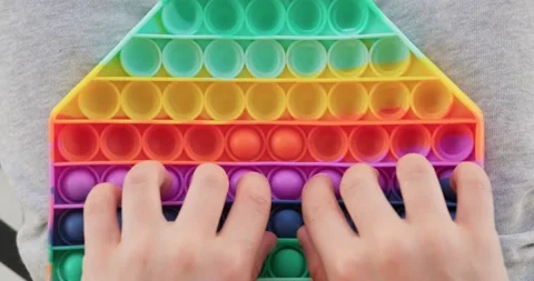 Close up of boy playing popit toy. Stock Footage 158329915