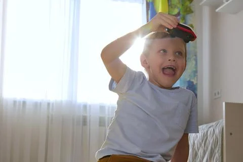 Close-up of a boy playing with a train in the nursery Stock Photos