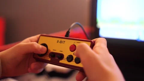 Close-up boy plays old vintage eight-bit 8 bit video console Stock Footage 270155907