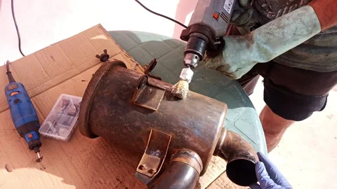 Close-up of boy removing rust with a drill on a car air filter outdoors Stock Footage 171413986