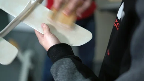 Close-up, Boy Sand the Wing of a Built Airplane Model Stock Footage 86667867