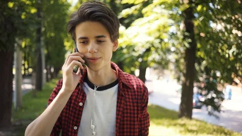 Close up boy speak on mobile phone walk in park guy business fashion hand child Stock Footage 92049538