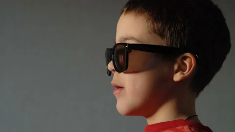 Close-up. A boy in sunglasses stands sideways 4K Stock Footage 126806870