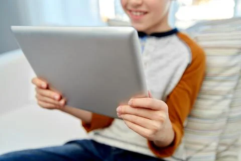 Close up of boy with tablet pc computer at home Stock Photos