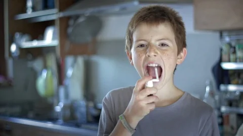 Close up of boy taking spray medicine Stock Footage 72818585