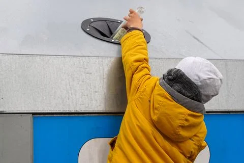 Close up boy throwing plastic bottle recycling container. Hand kid put bottle Stock Photos