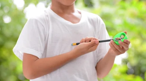 Close up boy use sharpener for black pencil Stock Footage 54060446