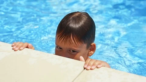 Close-up boy's face in the pool. Curious child having fun in the swimming pool Stock Footage 119146454