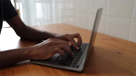 Close-up of a boy's hands typing using a laptop keyboard Stock Footage