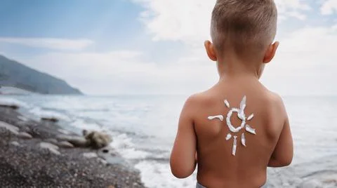 Close-up of a boy's shoulder with a sunscreen pattern made with sunscreen Stock Photos
