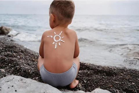 Close-up of a boy's shoulder with a sunscreen pattern made with sunscreen Stock Photos