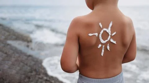 Close-up of a boy's shoulder with a sunscreen pattern made with sunscreen Stock Photos