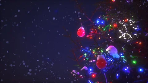 Close-up branches of Christmas tree with colorful garland lights surrounded by 動画素材 101462277